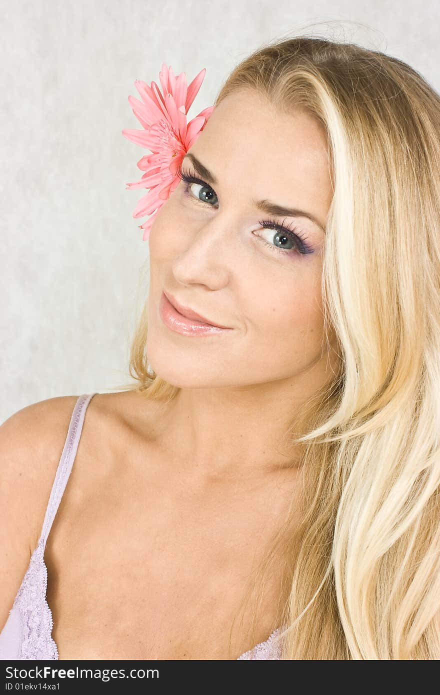 Blond girl with chrysanthemum in studio shot