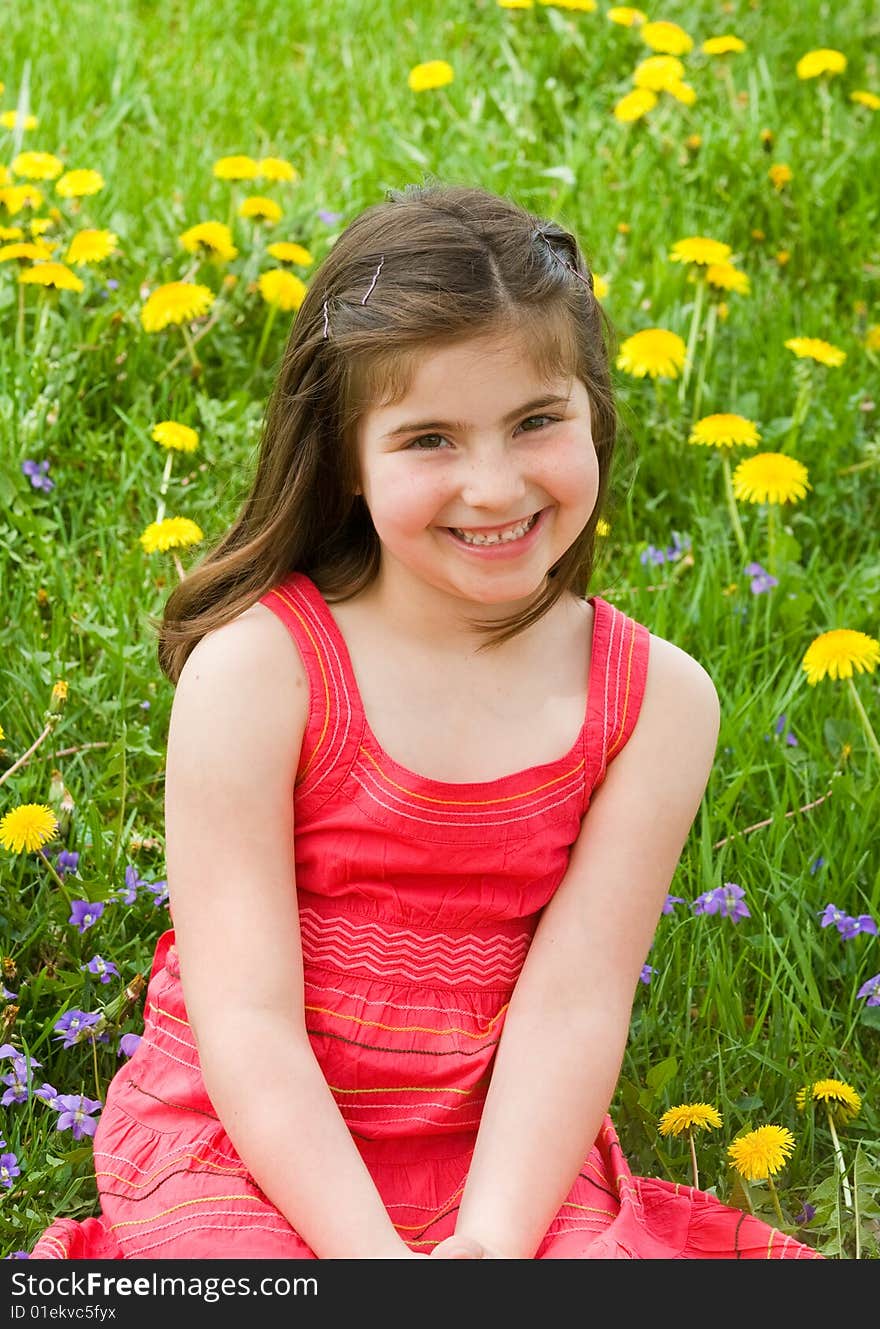 Girl Smiling in Front of Flowers