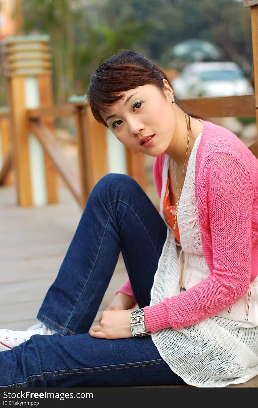 A beautiful Young girl Sit on the ground ,from china. A beautiful Young girl Sit on the ground ,from china