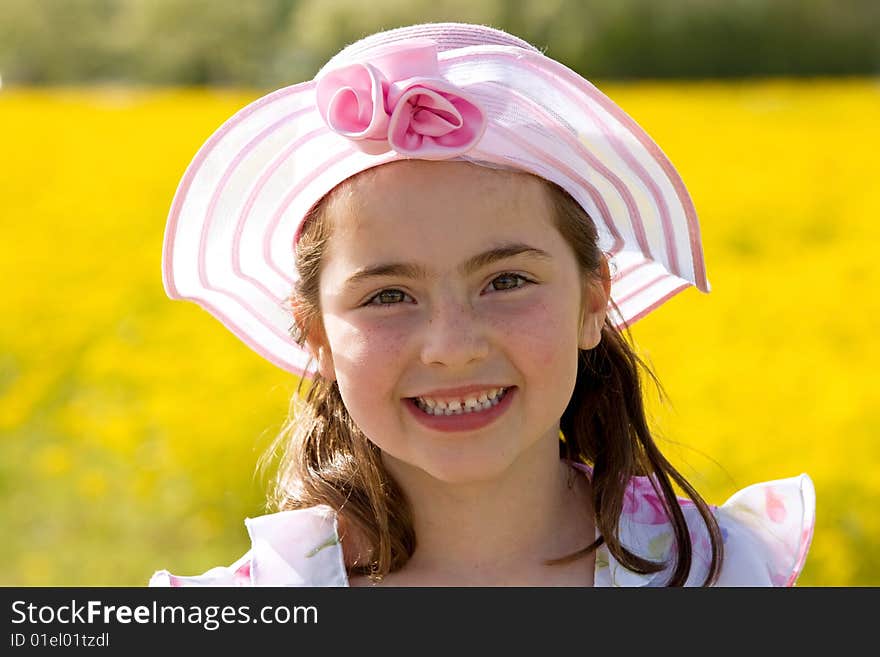 Girl Smiling In Front Of Flowers