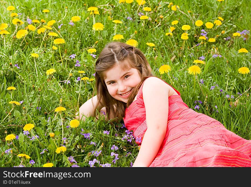 Girl Smiling In Front Of Flowers