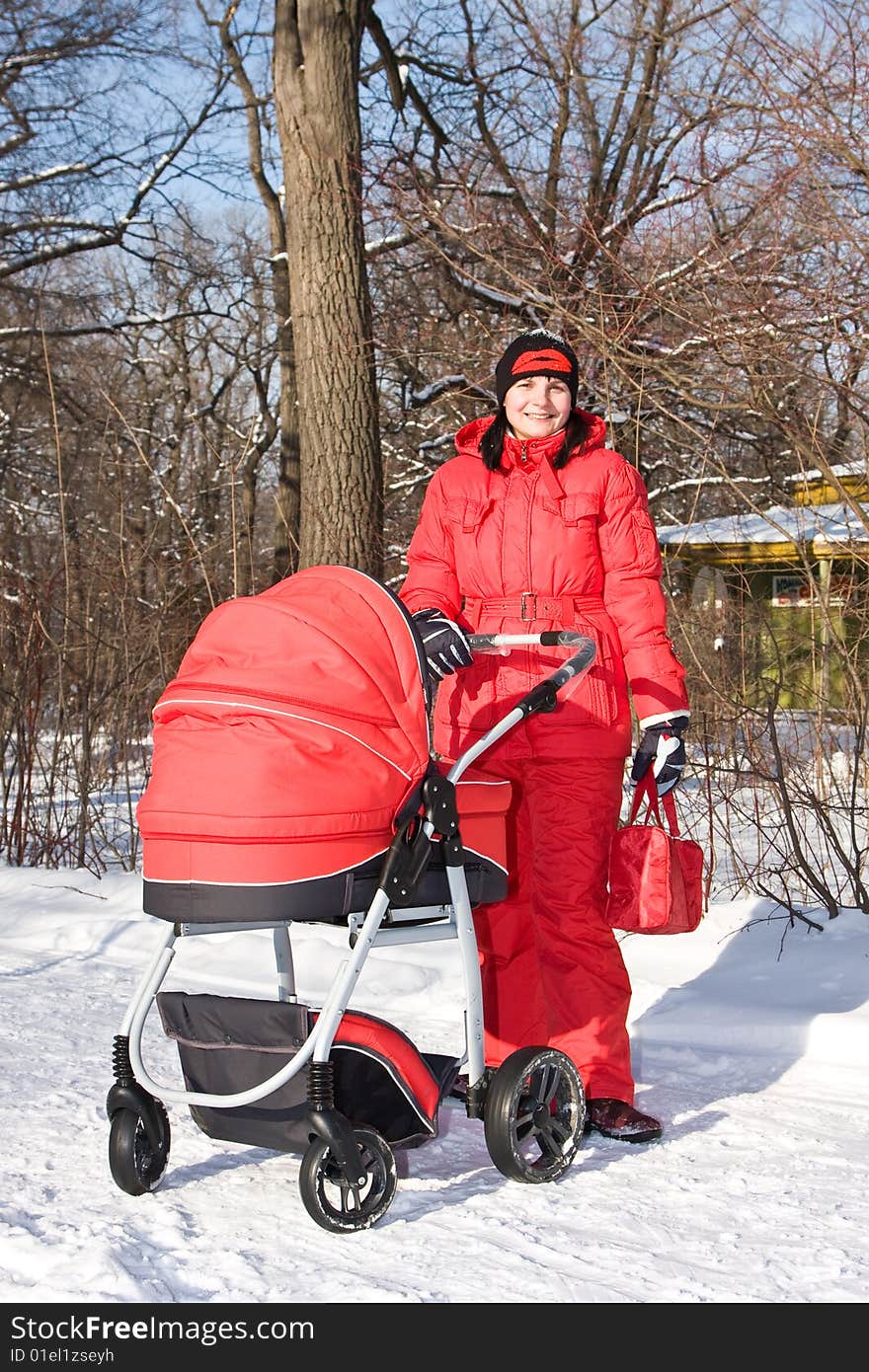 Young woman in red with red baby carriage