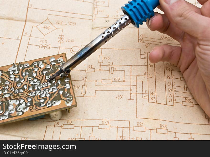 Soldering iron on diagram background