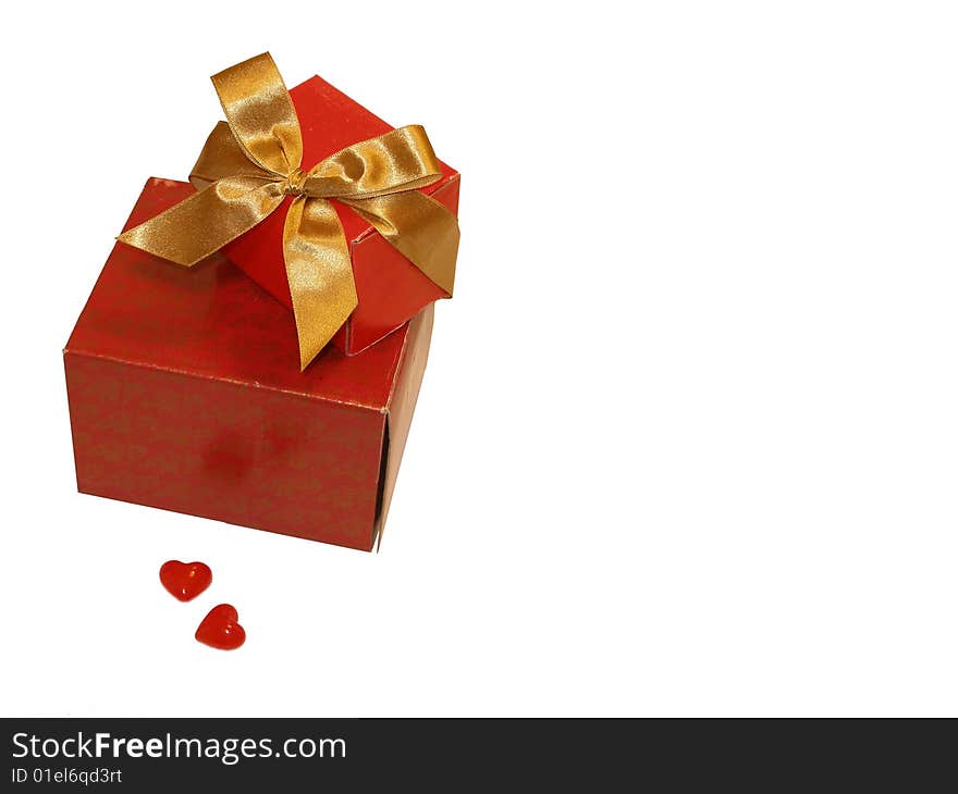 Two red gifts with a gold ribbon and two hearts