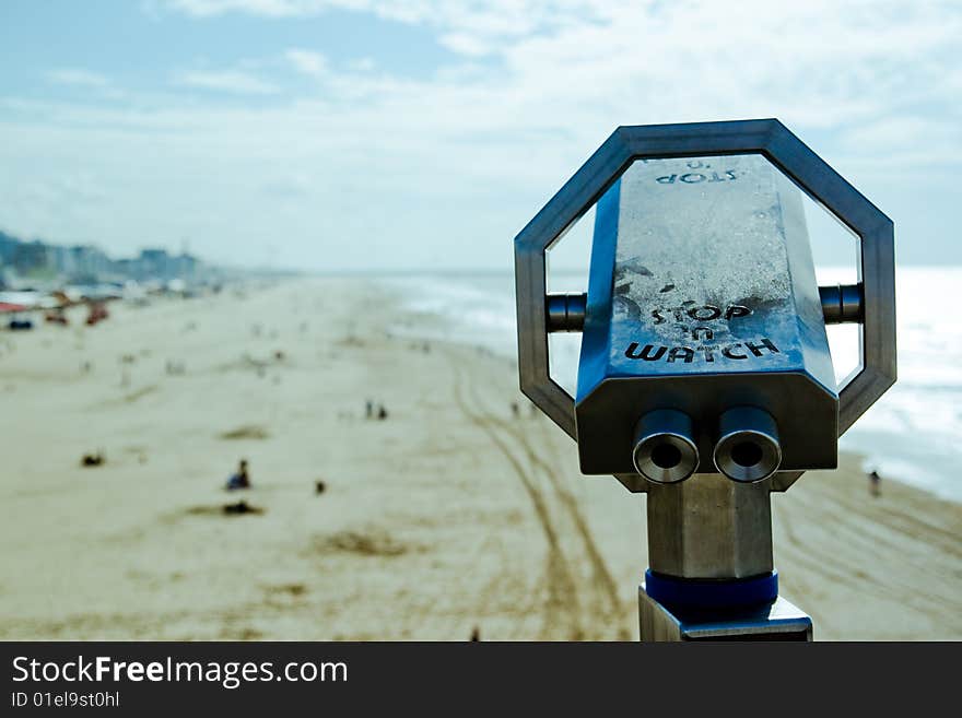 Beach telescope overlooking a beach, focus on the telescope.