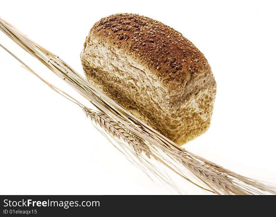 Bread and wheat isolated on white background