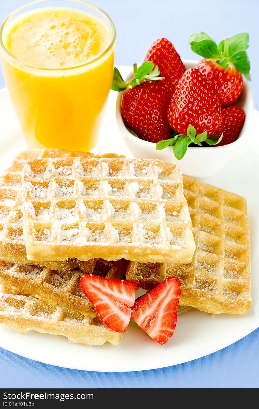 Tasty wafers with fresh strawberry and orange juice. Tasty wafers with fresh strawberry and orange juice