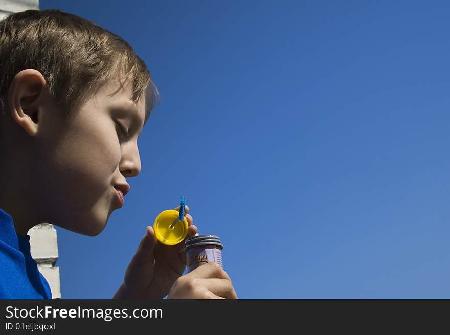 A boy blowing soap bubbles