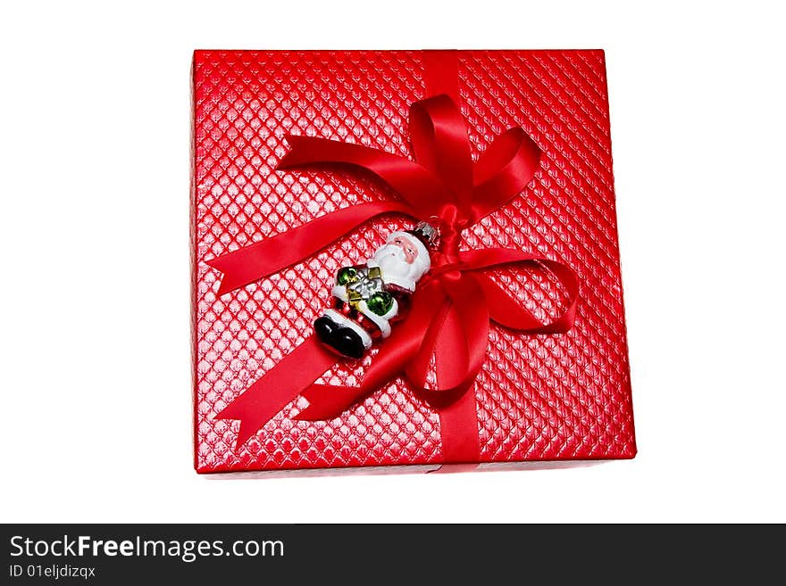 A nicely wrapped Christmas gift in red with santa claus on white background. A nicely wrapped Christmas gift in red with santa claus on white background