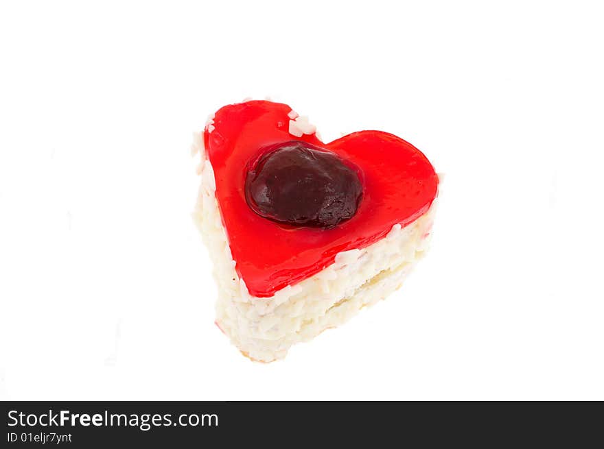 Cake in the form of heart in jelly with a strawberry in a coconut shaving on white