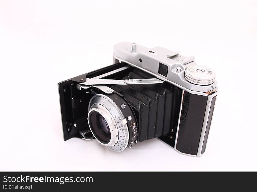 Antique folding camera on the whithe. Antique folding camera on the whithe