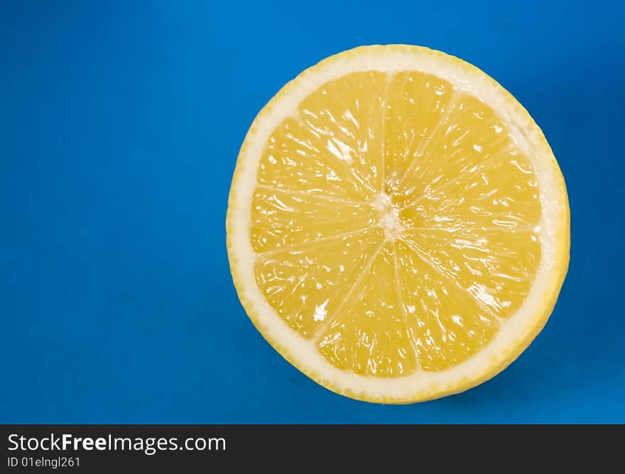 Juicy lemon isolated on blue background. Juicy lemon isolated on blue background