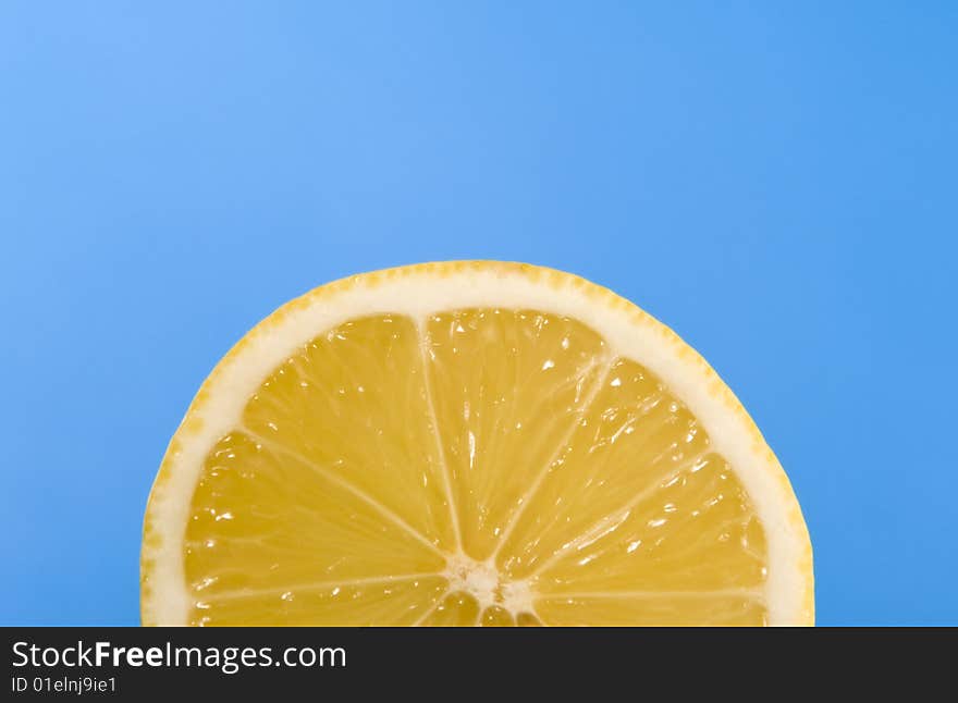 Juicy lemon isolated on blue background. Juicy lemon isolated on blue background