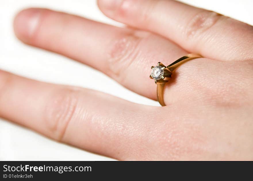 Engagement ring on woman's hand isolated on white