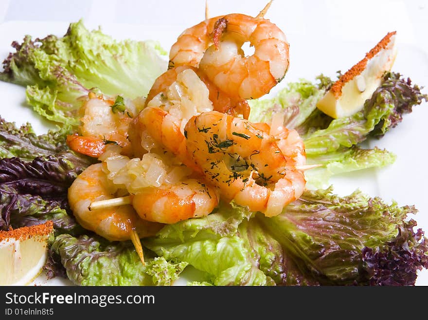 Shrimp's salad on white plate