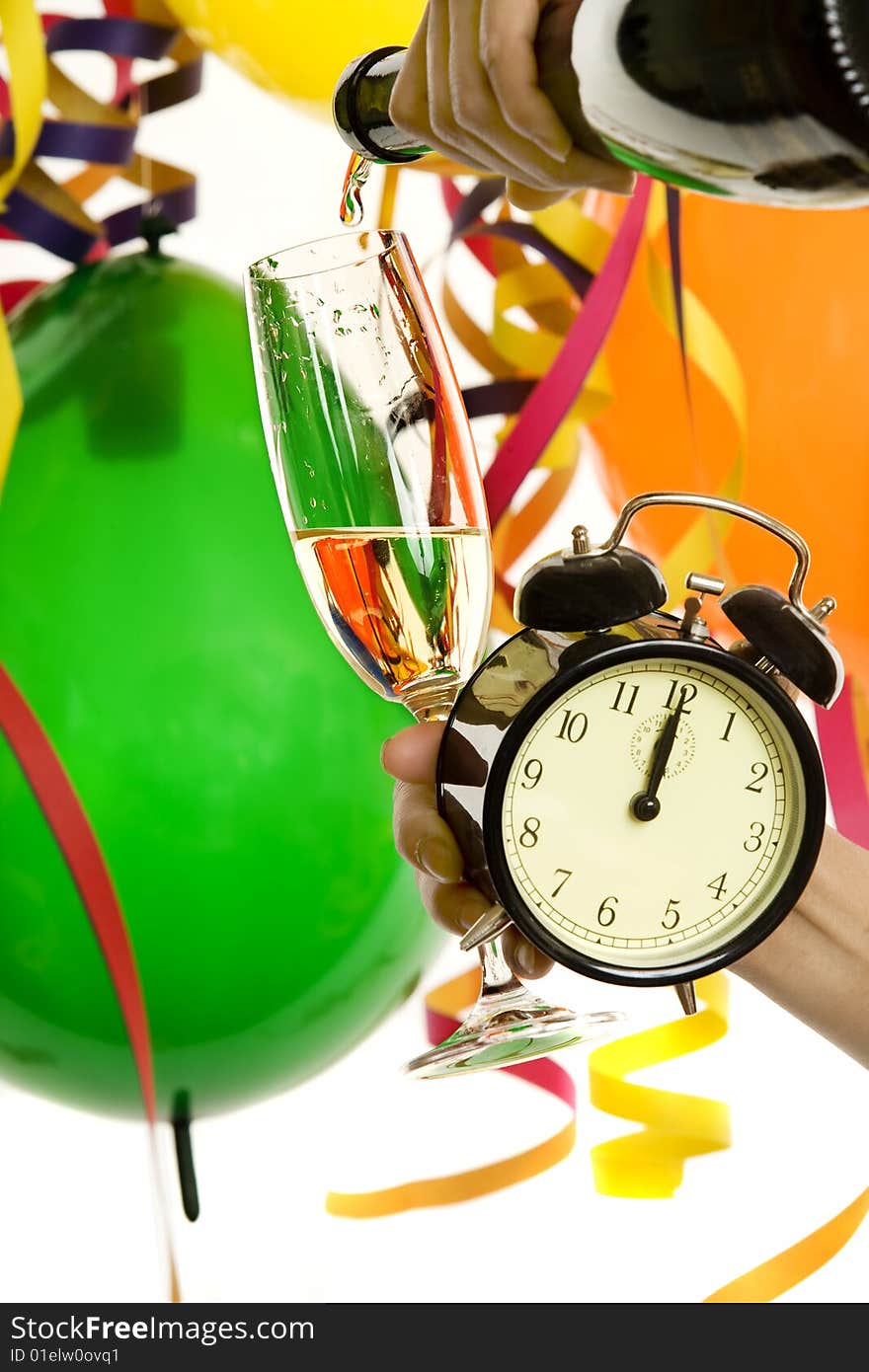 Turn of the year, New Year with champagne and clock, in the background balloons