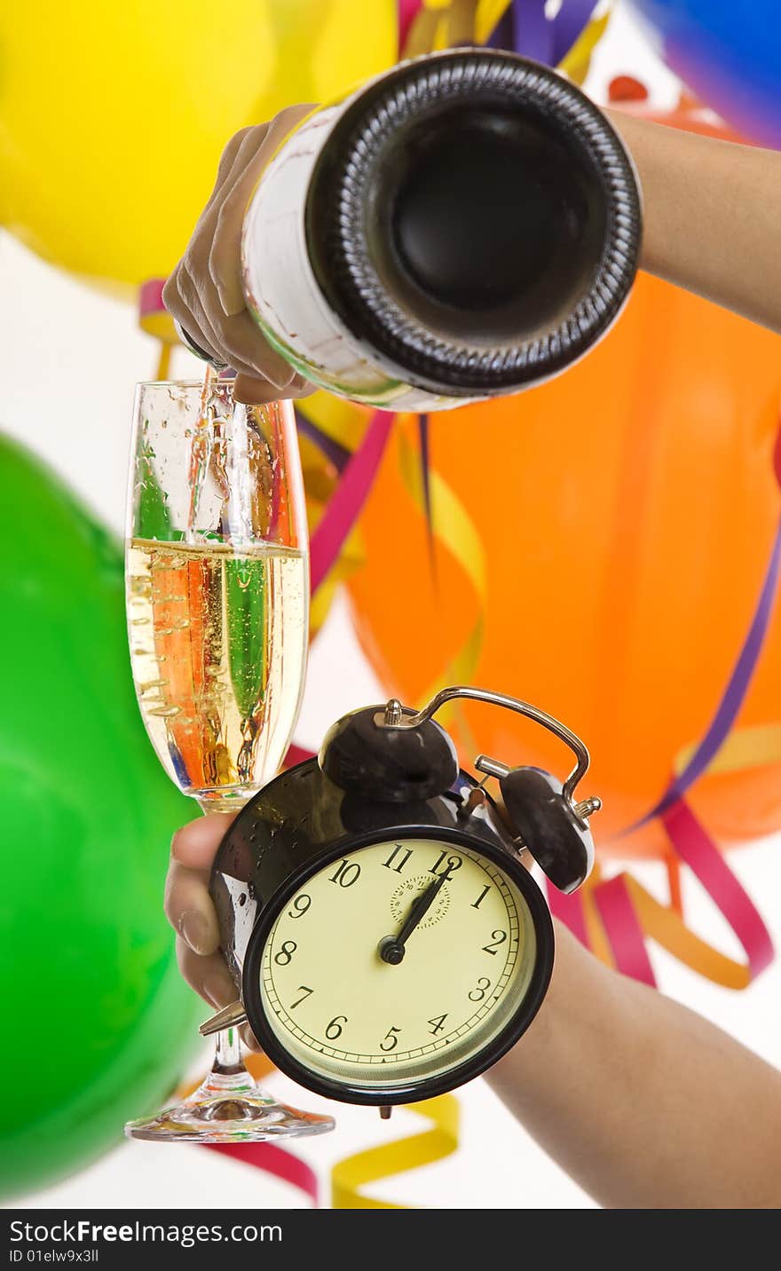 Turn of the year, New Year with champagne and clock, in the background balloons