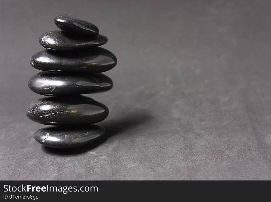 Stack of zen stones on gray background