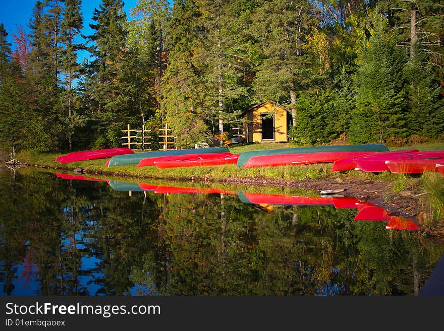 Kayaks lined up on lake shore. Kayaks lined up on lake shore