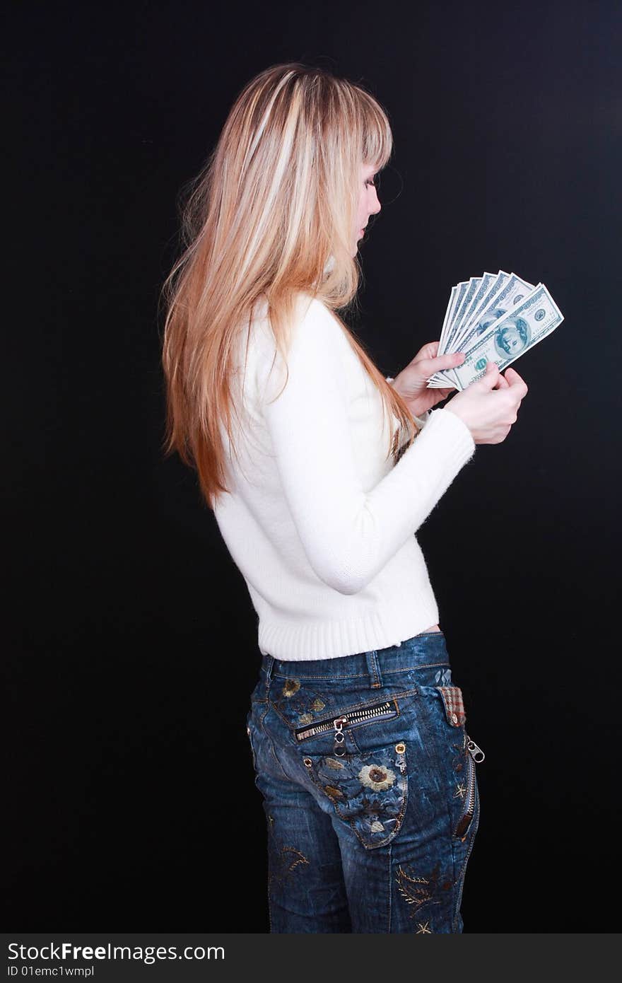 Young girl count dollars on black background