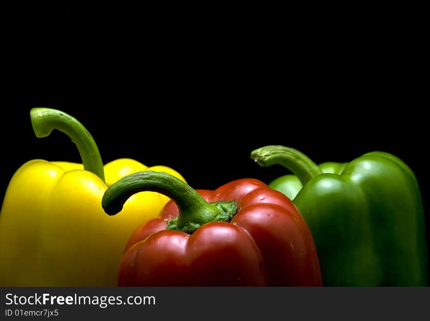 Yellow red and green pepper with black background. Yellow red and green pepper with black background