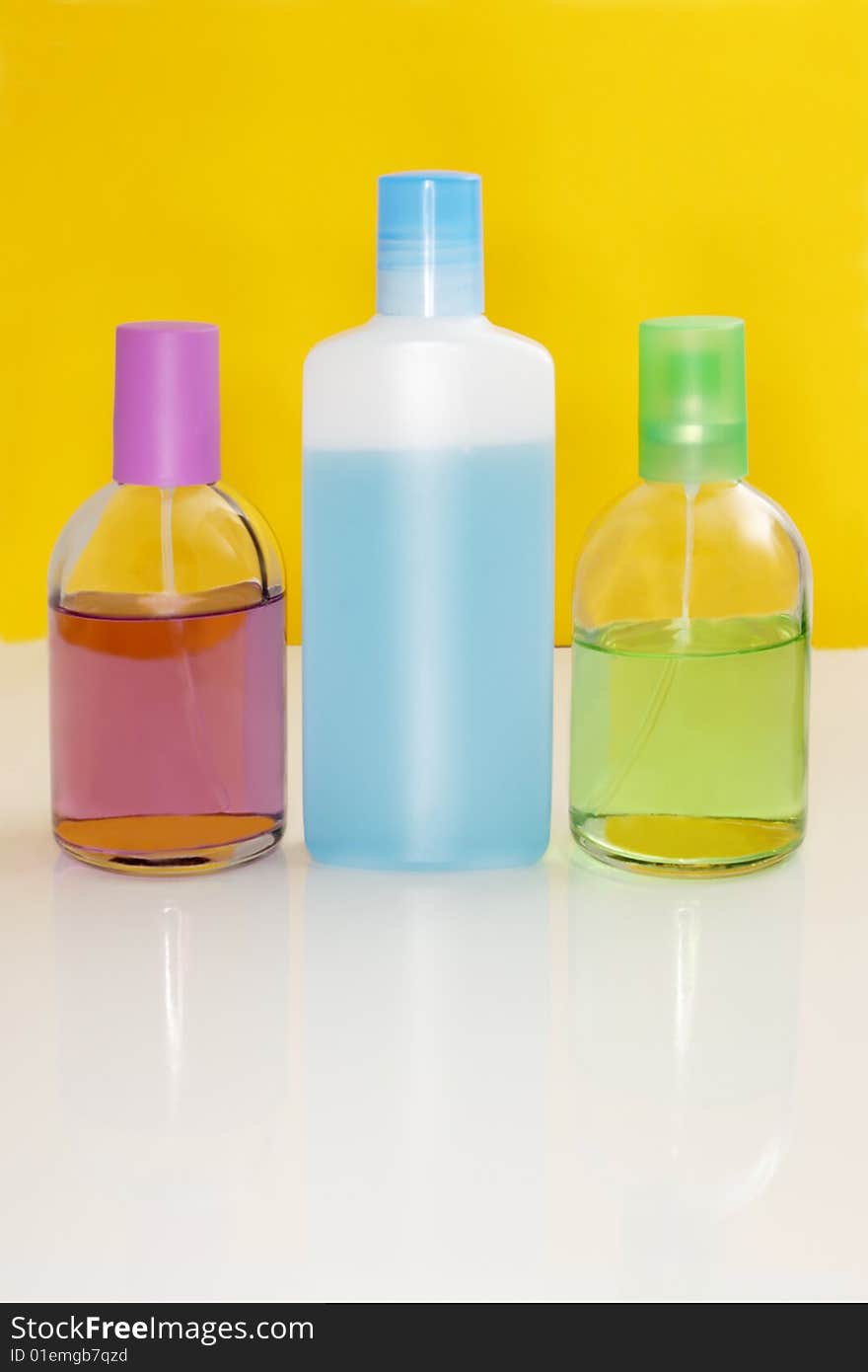 Perfumery bottles on a color background