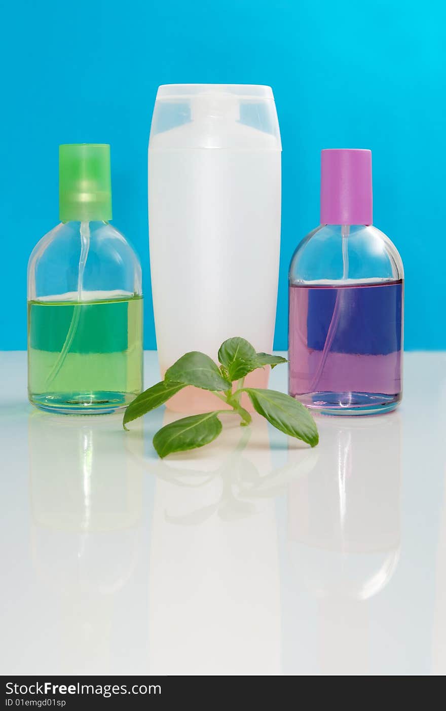 Perfumery bottles on a color background