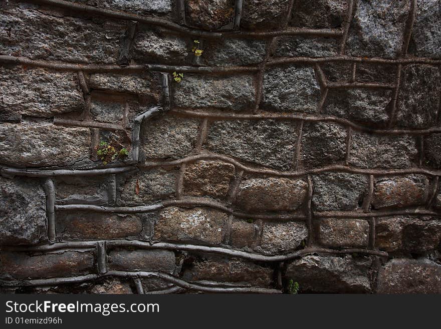 Rustic Random Stone Wall with thick Mortar and Weeds