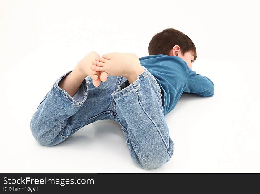 Adorable barefoot boy with toes in the air.