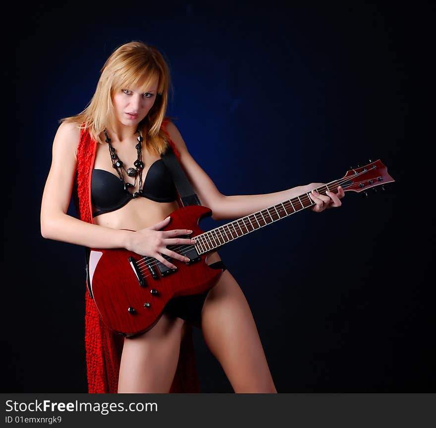 Portrait of a young woman with red electric guitar. Portrait of a young woman with red electric guitar