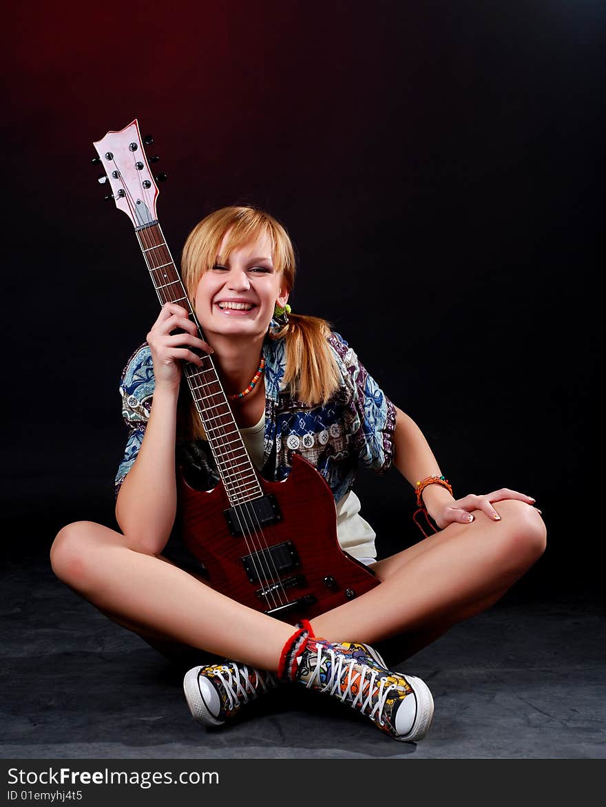 Portrait of a young woman with red electric guitar. Portrait of a young woman with red electric guitar