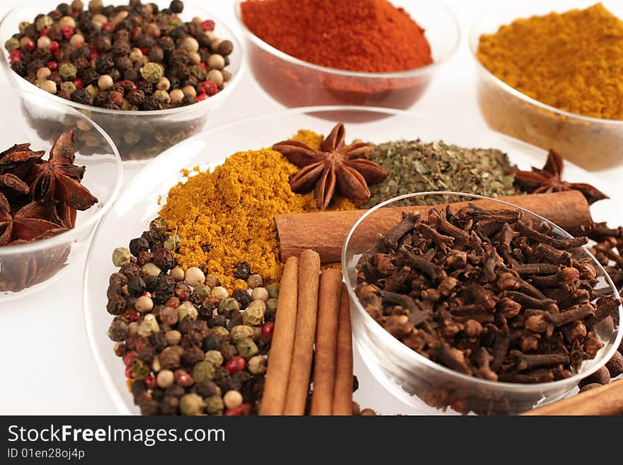 Spices in small glass bowl isolated on white. Spices in small glass bowl isolated on white