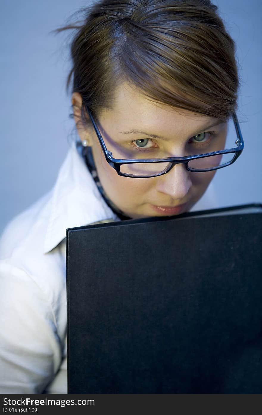 Business woman is holding a folder in her hands. Business woman is holding a folder in her hands.