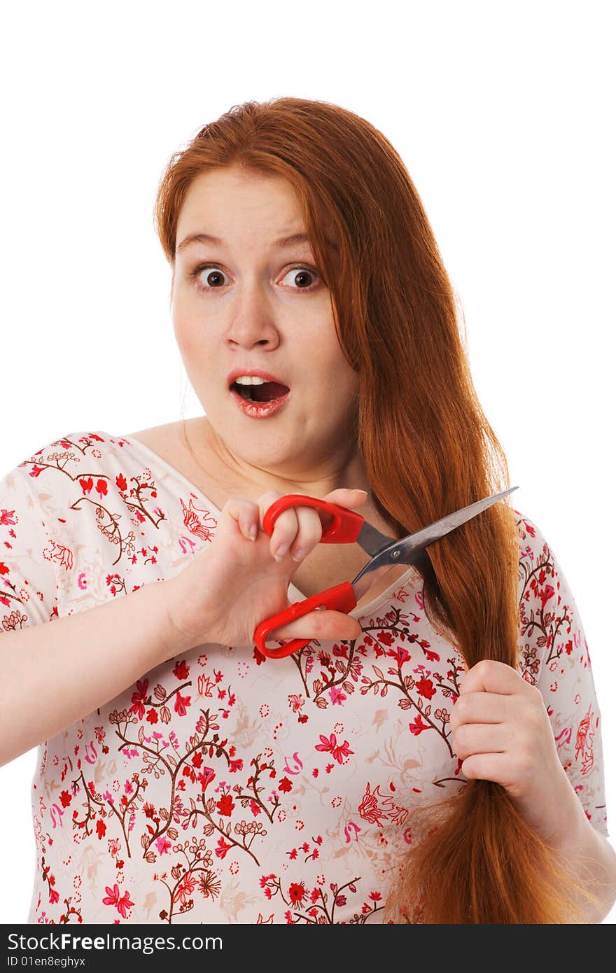 The young woman cuts red hair, is afraid