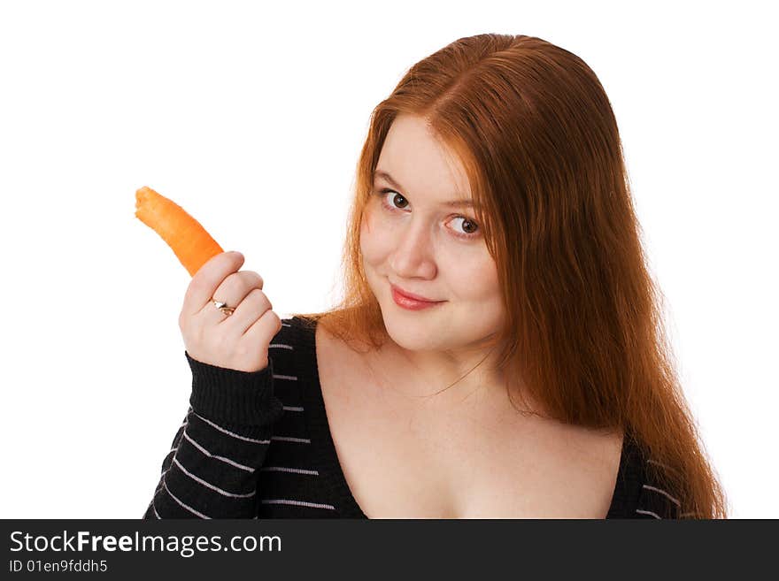 The young beautiful woman with long red hair and a carrot. The young beautiful woman with long red hair and a carrot