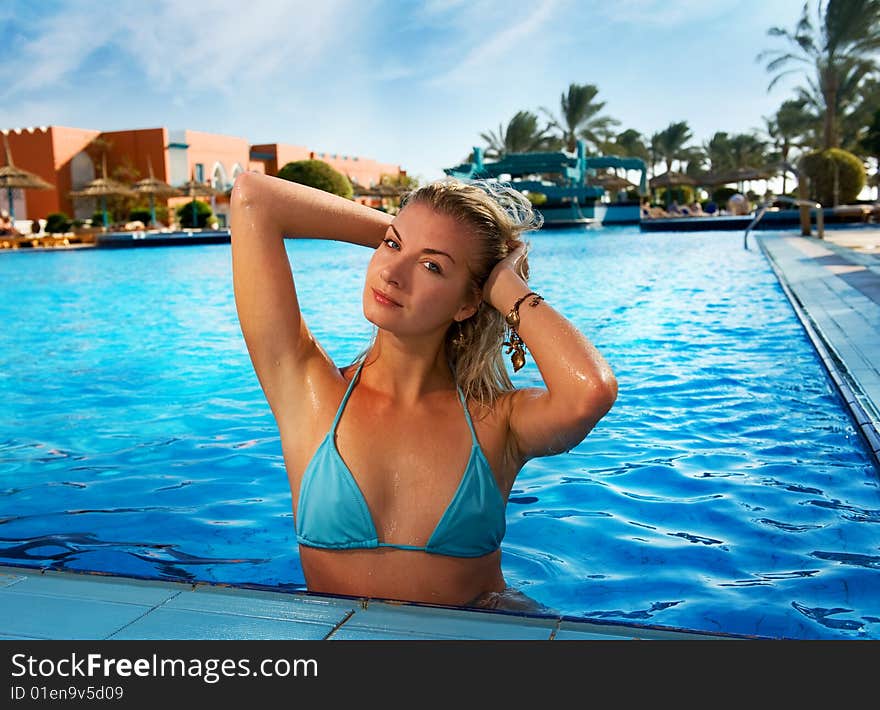 Beautiful blond woman relaxing in the pool