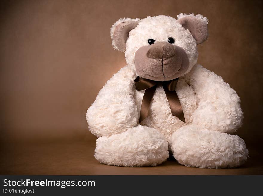 Teddy bear toy on a brown background