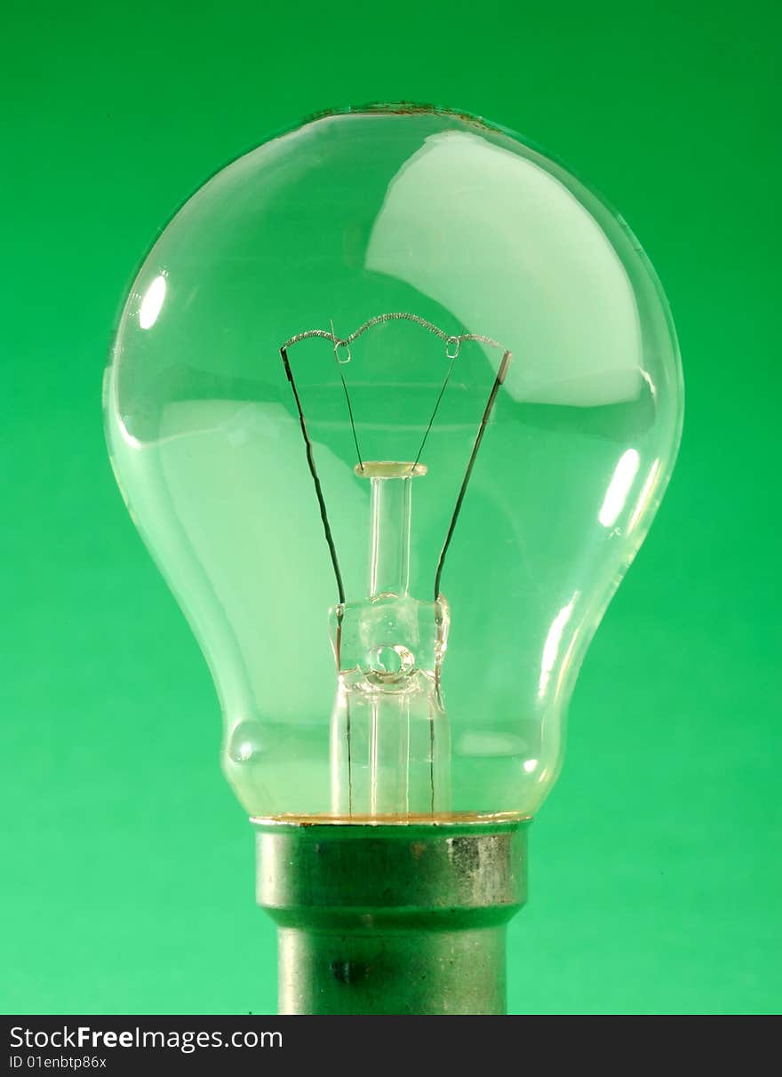 Old style Light bulb on a green background