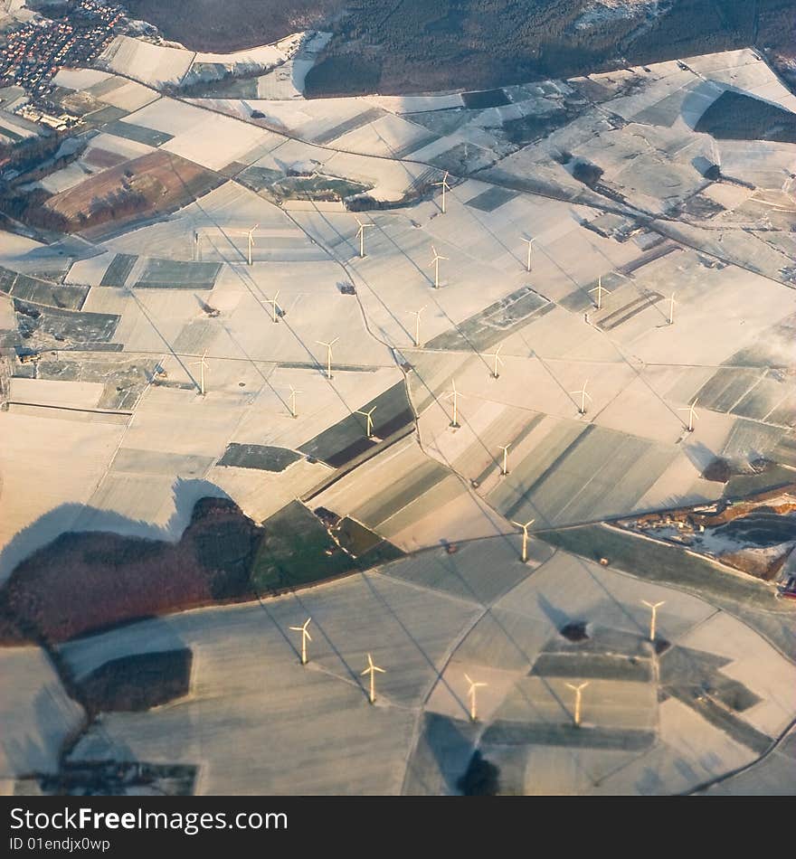 Windmills from the air im winter seasion with snow and sunset. Windmills from the air im winter seasion with snow and sunset