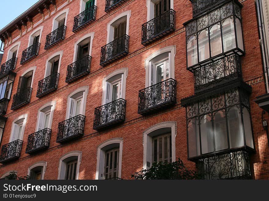 THe front of a living house with balconies. Madrid, Spain. THe front of a living house with balconies. Madrid, Spain.