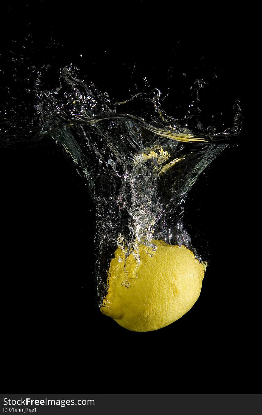 Lemon in water with bubbles on black ground. Lemon in water with bubbles on black ground