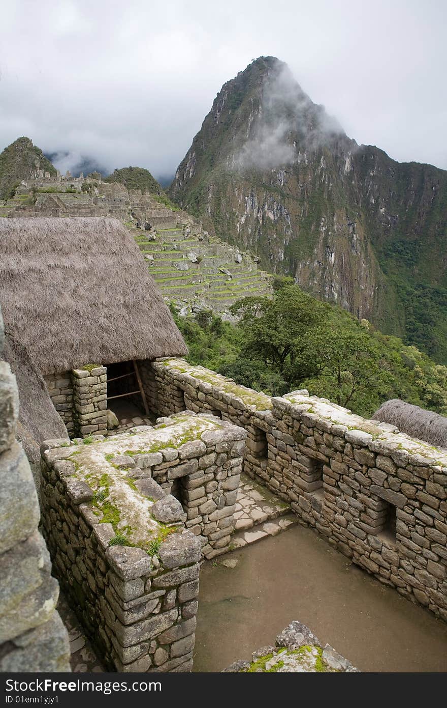 Machu Picchu is a pre-Columbian Inca site located 2,430 metres (8,000 ft) above sea level. It is situated on a mountain ridge above the Urubamba Valley in Peru, which is 80 kilometres (50 mi) northwest of Cusco and through which the Urubamba River flows. The river is a partially navigable headwater of the Amazon River.