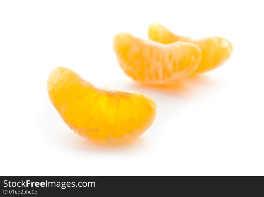 Several tangerine segments  on a  white background