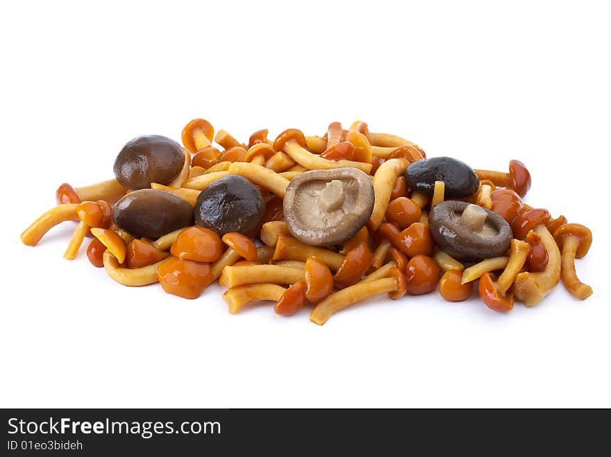 Some marinated honey agarics and black milk mushrooms isolated on the white background. Some marinated honey agarics and black milk mushrooms isolated on the white background