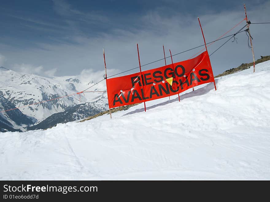 Snow landscape with a blue sky and a warning for avalanches, Spain