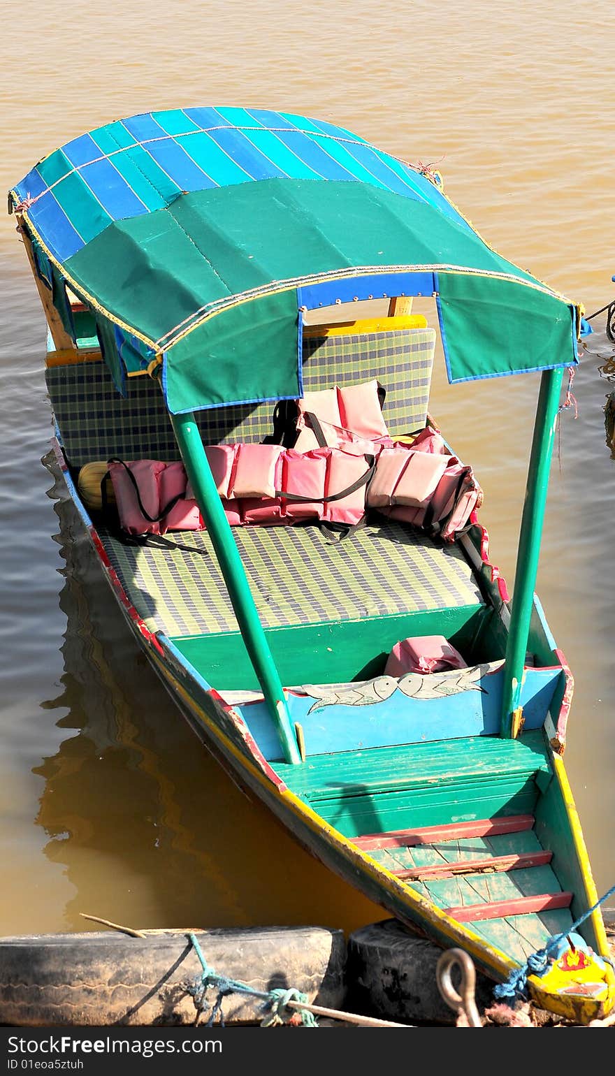 Green boat looking great in sunny day.