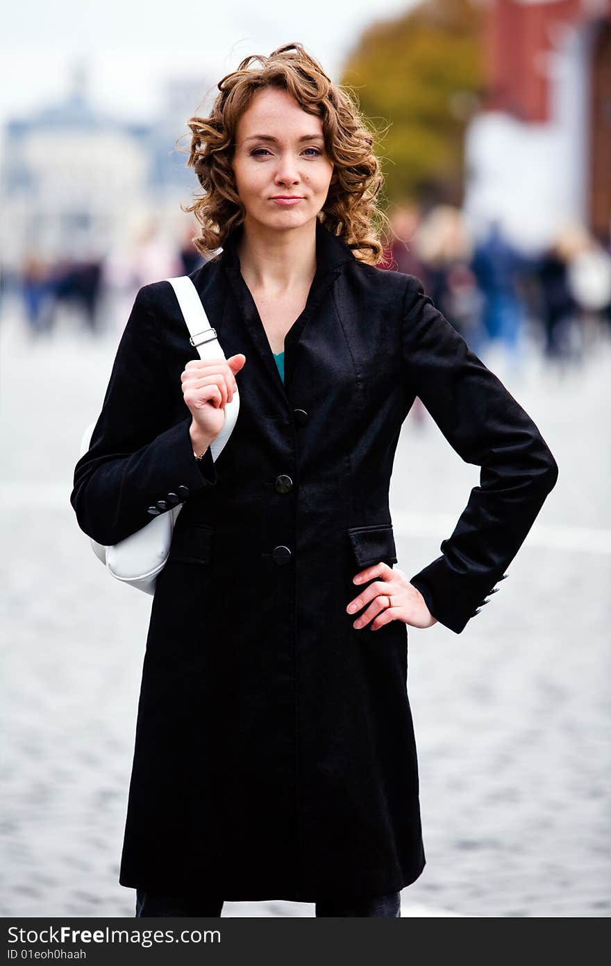 Attractive smiling woman standing by Kremlin in Moscow