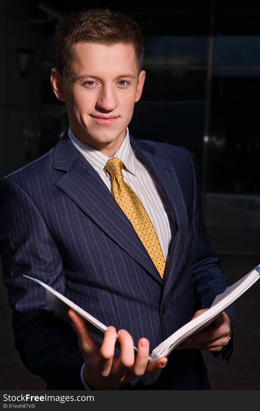 Friendly Businessman With Folder Outdoors