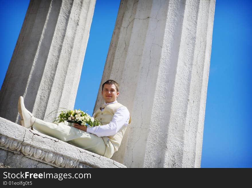 Groom with flowers waiting for a bride