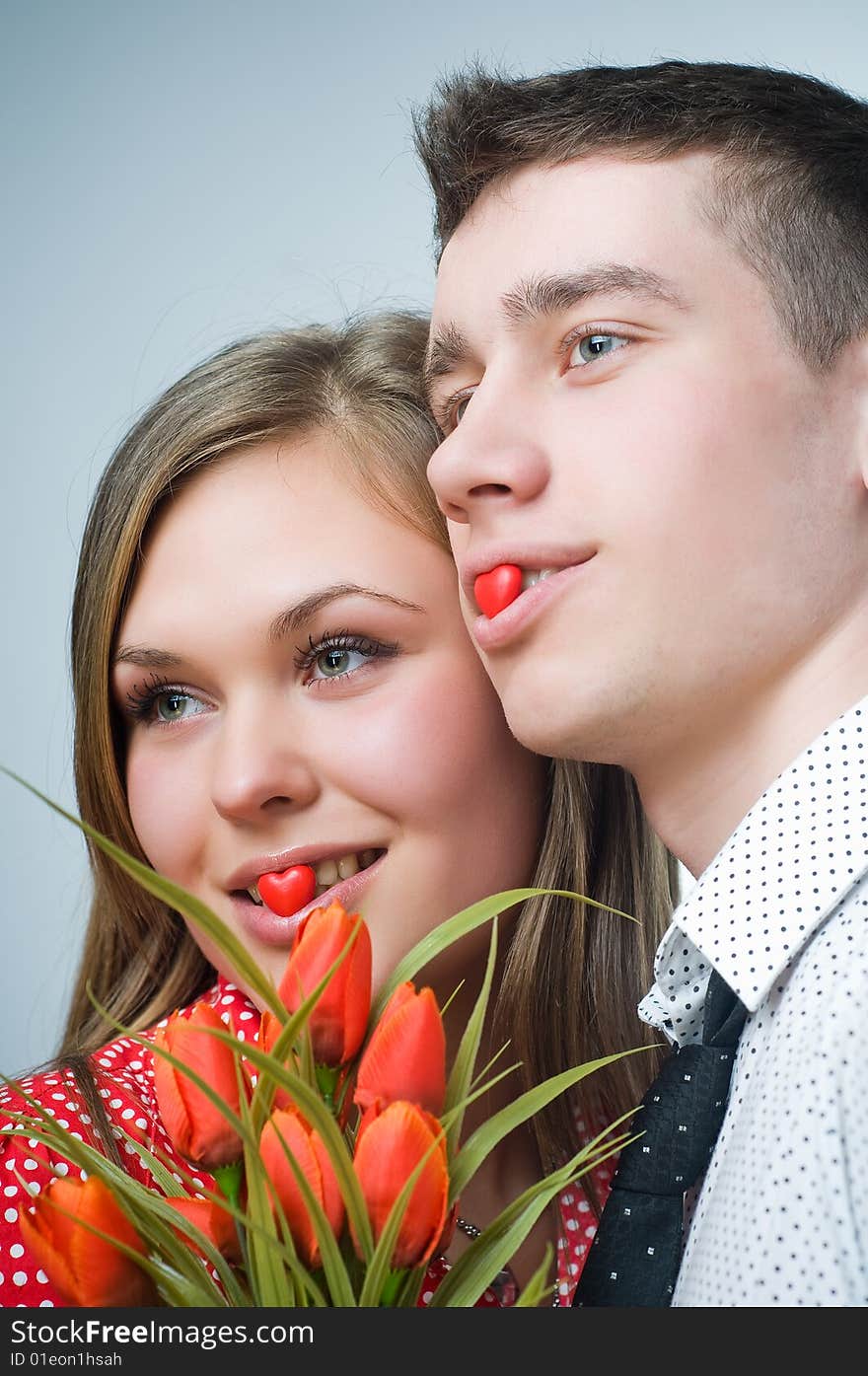 Beautiful couple with heart-shaped candies